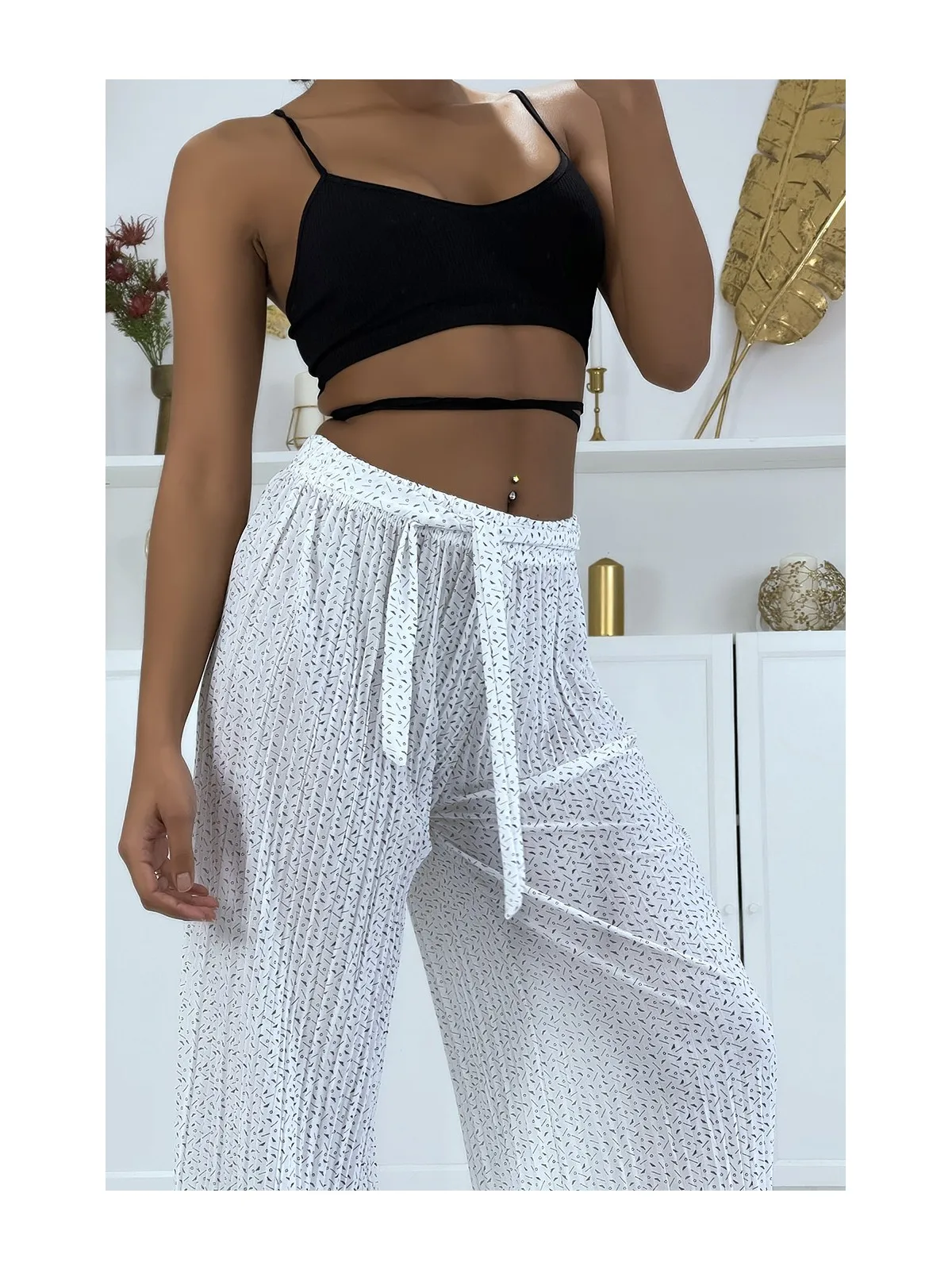 White pleated palazzo pants with pattern.